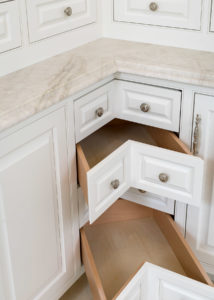 White Corner Drawers with raised panels inside of beaded inset cabinetry