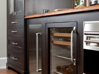 dark stained china cabinet with inset large open frame upper doors, slab and shaker drawer fronts below.