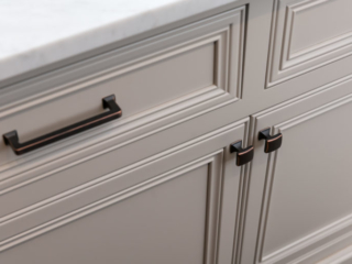 White inset pantry island cabinet with decorated recessed panel doors and Top Knobs Hardware: Contour knob and Ascendra Pull in Umbria