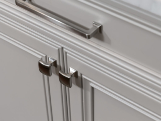 Top Knobs Ascendra Pull and Contour Knobs in Brushed Satin Nickel decorating off white inset cabinetry with recessed panels