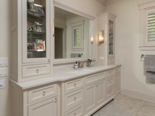 Beige painted master bathroom with glass panel doors and recessed panels