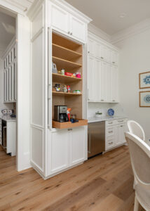 Eastburn Woodworks custom built pull out coffee bar inside of the pantry. White painted cabinetry with doors that tuck inside the cabinet.